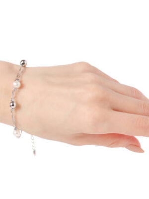 Silver female bracelet on a hand on a white background isolation