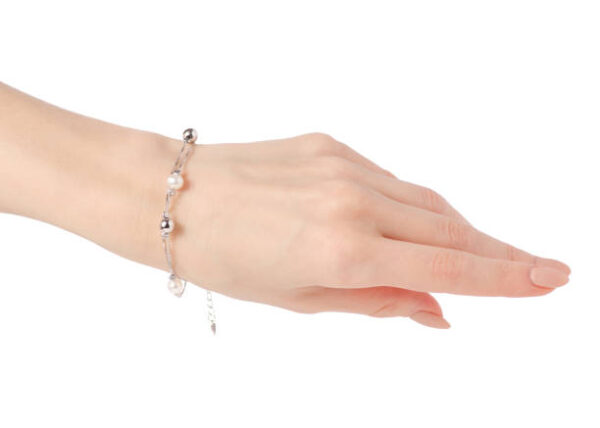 Silver female bracelet on a hand on a white background isolation